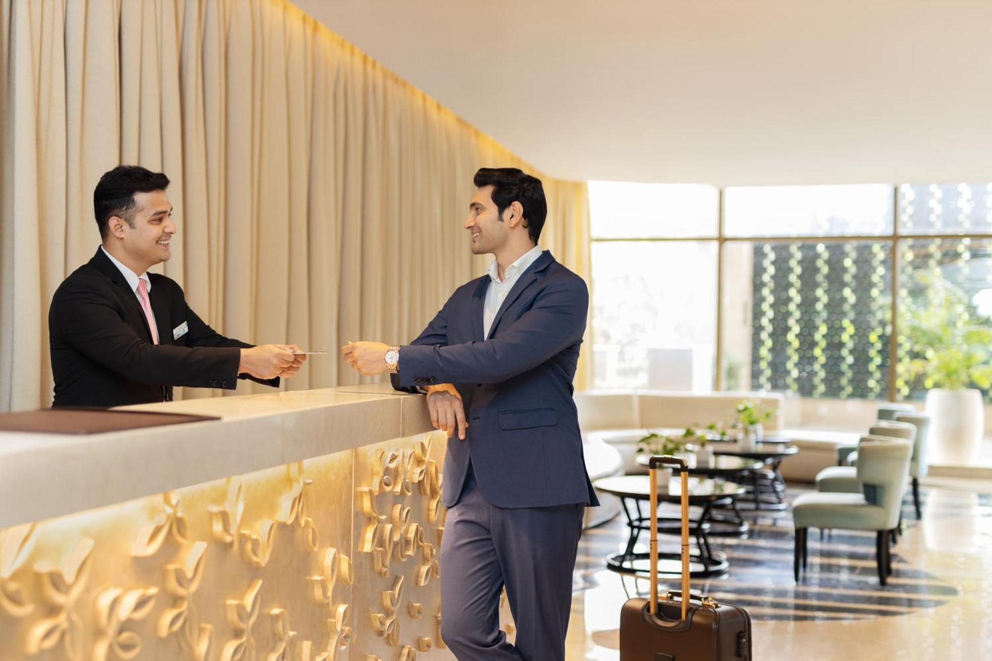 Radisson Blu Hotel New Delhi Dwarka Esterno foto A guest checking in at a hotel